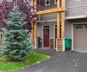 Modern riverfront condo with hot tub, entertainment & river views