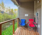 Modern riverfront condo with hot tub, entertainment & river views