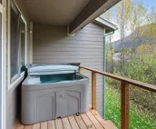 Modern riverfront condo with hot tub, entertainment & river views