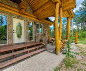 Custom cabin on 10 acres with firepit, wood stove, game room & forest views