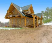 Custom cabin on 10 acres with firepit, wood stove, game room & forest views