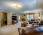 Hillside home with mountain view, wrap-around deck & great family room