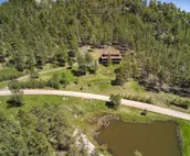 Hillside home with mountain view, wrap-around deck & great family room