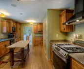 Hillside home with mountain view, wrap-around deck & great family room