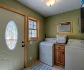 Hillside home with mountain view, wrap-around deck & great family room