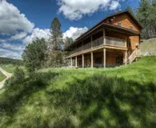 Hillside home with mountain view, wrap-around deck & great family room