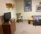 Room w/ a double bed and twin over twin bunk beds