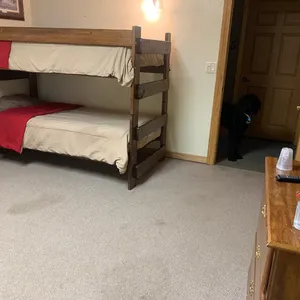 Room w/ a double bed and twin over twin bunk beds