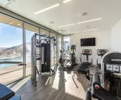 Modern home with three balconies, mountain views, and outdoor swimming pool. ...